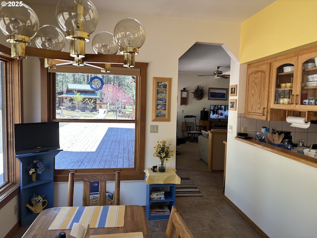 163 Goldenpine, Goldendale, WA 98620 - dining area with a ceiling fan, a chandelier, dark tile patterned flooring, and arched walkways