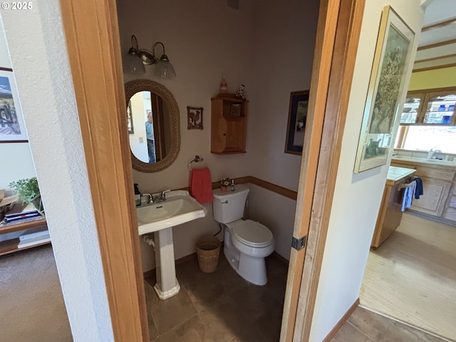 bathroom with toilet and a sink