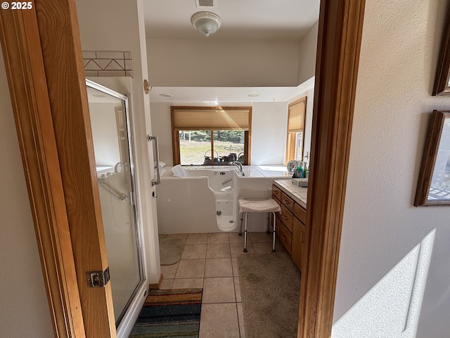 bathroom with a stall shower, tile patterned flooring, and visible vents