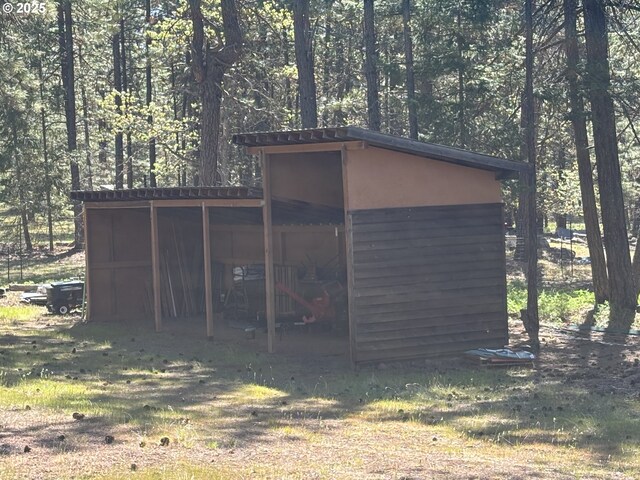 view of pole building with a wooded view