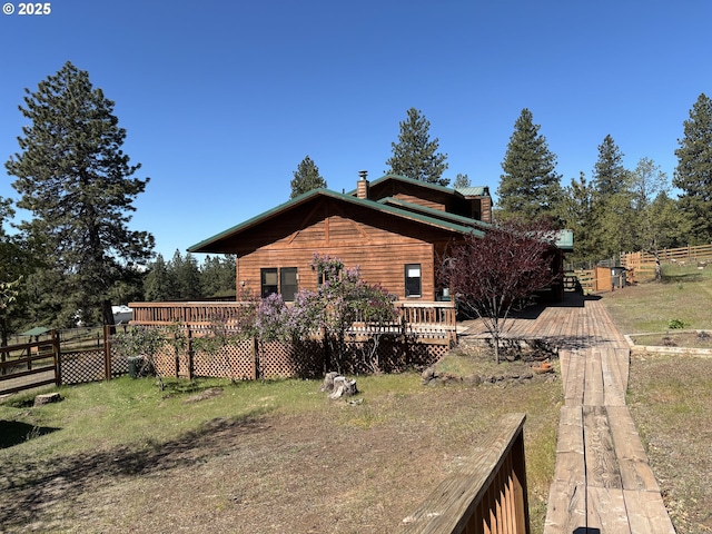 163 Goldenpine, Goldendale, WA 98620 - view of side of property featuring a wooden deck, fence, and a chimney