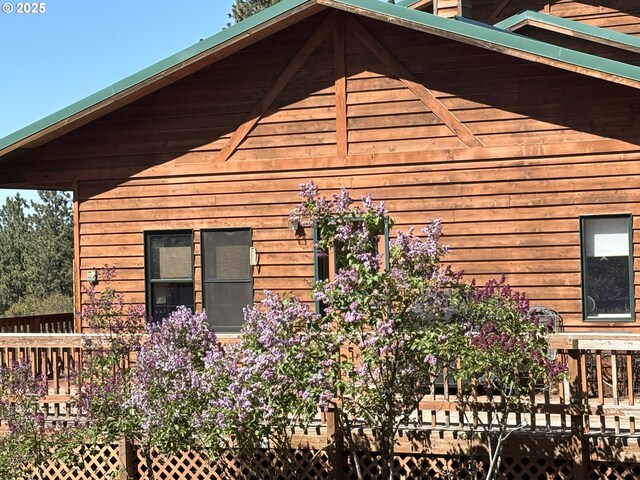 view of side of home with a wooden deck