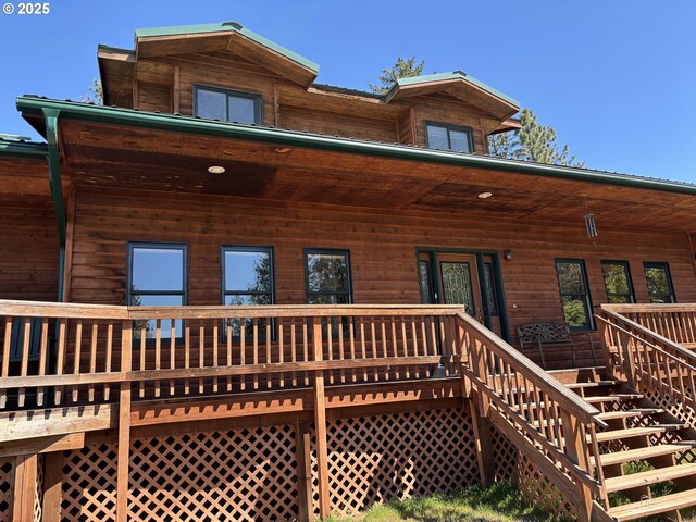 rear view of property featuring stairway and a porch