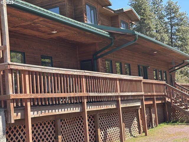 view of side of home featuring a wooden deck