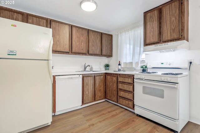 9259 SE Clay St, Portland, OR 97216 - kitchen with white appliances, under cabinet range hood, a sink, light countertops, and light wood-style floors