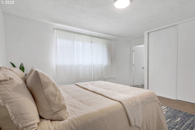 9259 SE Clay St, Portland, OR 97216 - bedroom featuring a textured ceiling, carpet floors, and a closet