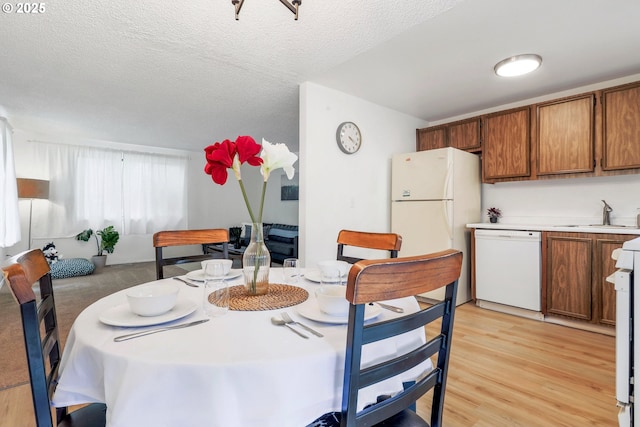 9259 SE Clay St, Portland, OR 97216 - dining space with light wood-style flooring and a textured ceiling