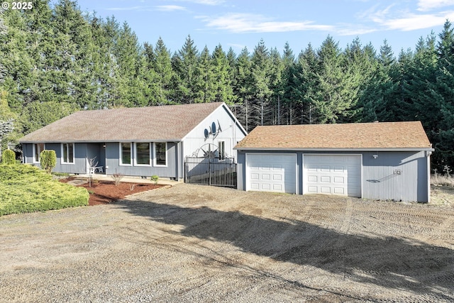 view of front of property featuring a garage and an outdoor structure