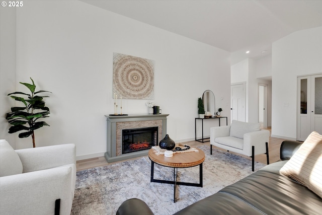 living room featuring vaulted ceiling and light hardwood / wood-style flooring