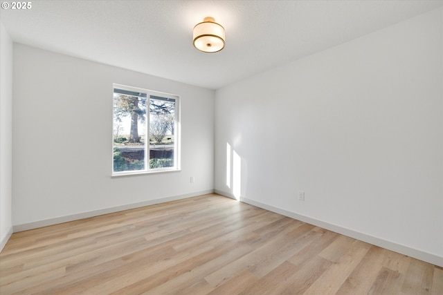 empty room with light hardwood / wood-style flooring