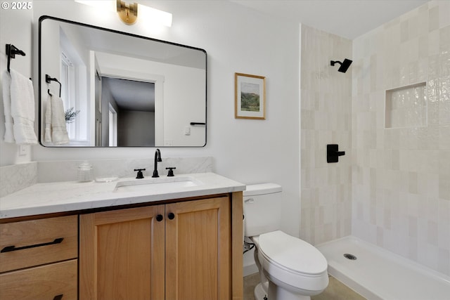 bathroom featuring walk in shower, vanity, and toilet