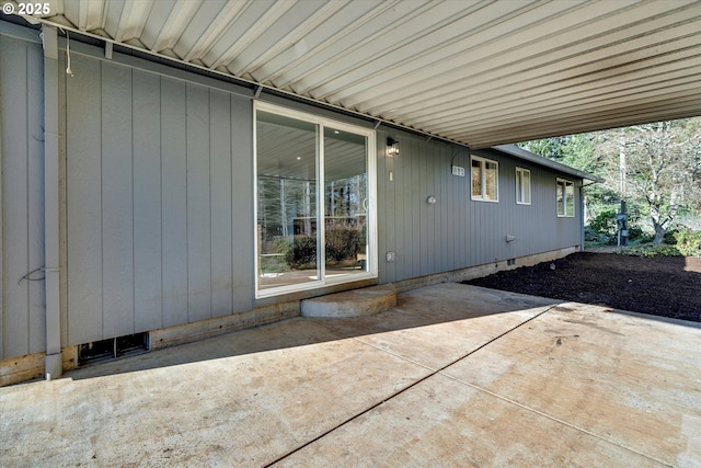 view of exterior entry with a patio