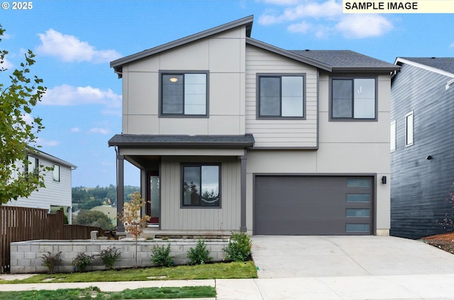 contemporary house featuring a shingled roof, an attached garage, concrete driveway, and fence