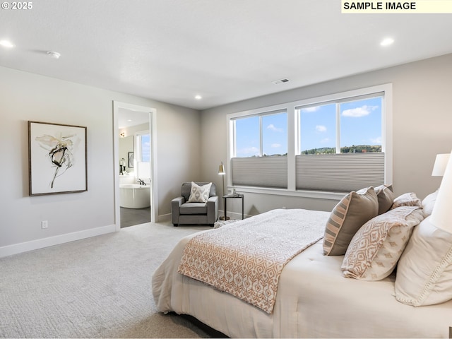 bedroom featuring connected bathroom and light carpet