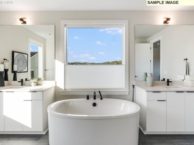 bathroom featuring vanity and a bath