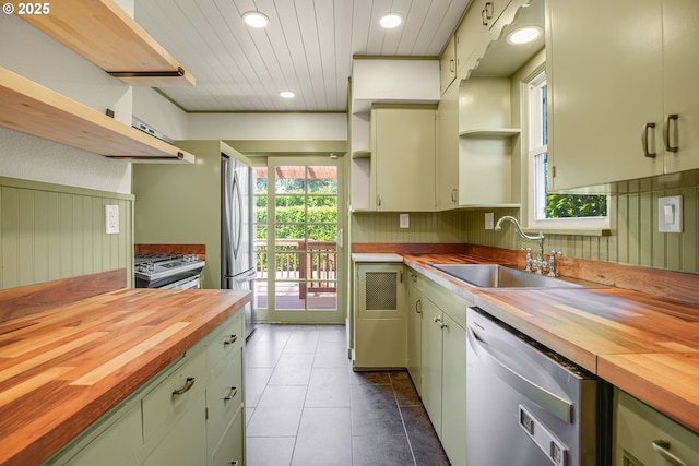 1605 NE 76th Ave, Portland, OR 97213 - kitchen featuring open shelves, wood counters, stainless steel appliances, green cabinets, and recessed lighting