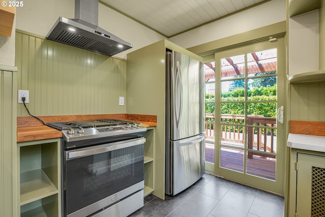 1605 NE 76th Ave, Portland, OR 97213 - kitchen featuring stainless steel appliances, wall chimney range hood, tile patterned flooring, butcher block countertops, and open shelves