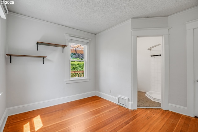 1605 NE 76th Ave, Portland, OR 97213 - unfurnished bedroom featuring a textured ceiling, light wood-type flooring, and ornamental molding