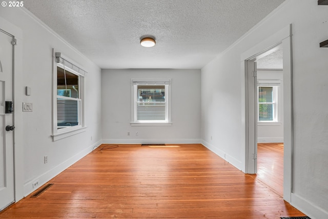 1605 NE 76th Ave, Portland, OR 97213 - unfurnished room featuring a textured ceiling, wood-type flooring, and crown molding