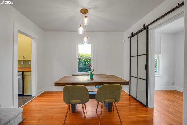 1605 NE 76th Ave, Portland, OR 97213 - dining room with a barn door and light wood finished floors