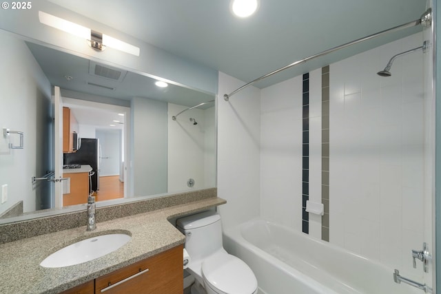 full bathroom with washtub / shower combination, vanity, and toilet