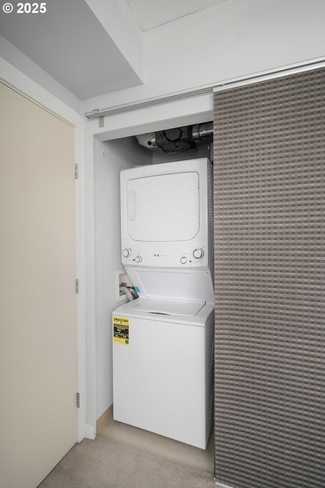 washroom with stacked washer / dryer