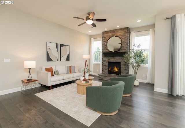 16922 NW Madrone St, Portland, OR 97229 - living area featuring a stone fireplace, baseboards, ceiling fan, dark wood-style flooring, and recessed lighting