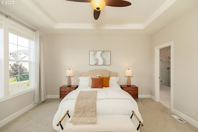 16922 NW Madrone St, Portland, OR 97229 - bedroom with light colored carpet, multiple windows, and a tray ceiling