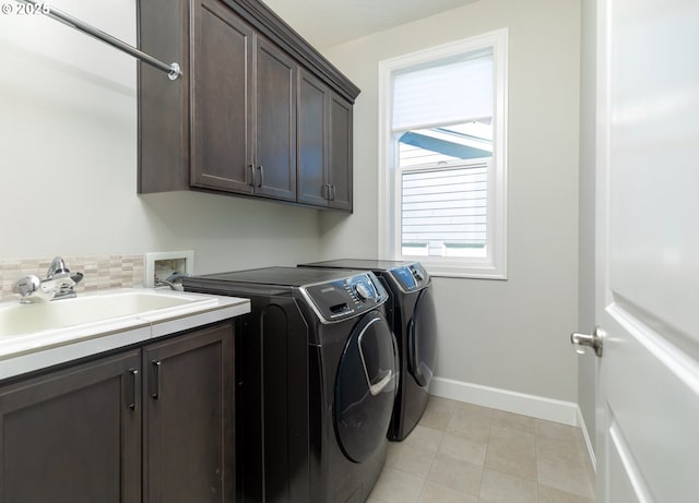 16922 NW Madrone St, Portland, OR 97229 - washroom with separate washer and dryer, cabinet space, and baseboards