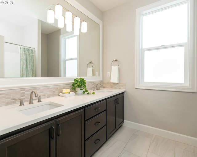 16922 NW Madrone St, Portland, OR 97229 - full bathroom with plenty of natural light, double vanity, and tasteful backsplash