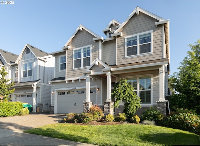 16922 NW Madrone St, Portland, OR 97229 - craftsman-style home featuring an attached garage, driveway, stone siding, and a front lawn
