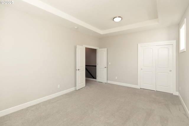 16922 NW Madrone St, Portland, OR 97229 - unfurnished bedroom featuring a raised ceiling, carpet, baseboards, and a closet