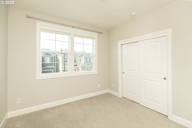 16922 NW Madrone St, Portland, OR 97229 - unfurnished bedroom featuring light carpet, baseboards, and a closet