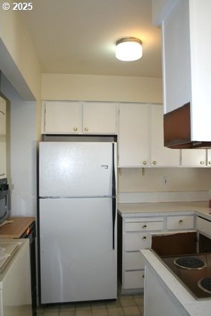 14737 SW Hall Blvd, Tigard, OR 97224 - kitchen featuring freestanding refrigerator, electric stovetop, white cabinets, and light countertops
