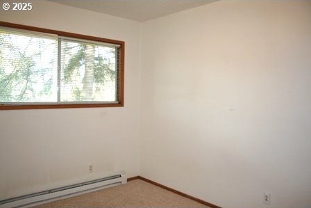 14737 SW Hall Blvd, Tigard, OR 97224 - carpeted spare room with a baseboard radiator and baseboards