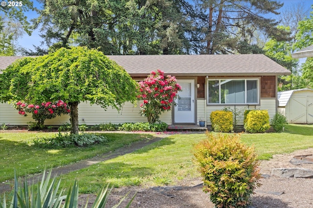 14737 SW Hall Blvd, Tigard, OR 97224 - view of front of home featuring a storage unit, a front lawn, roof with shingles, and an outbuilding