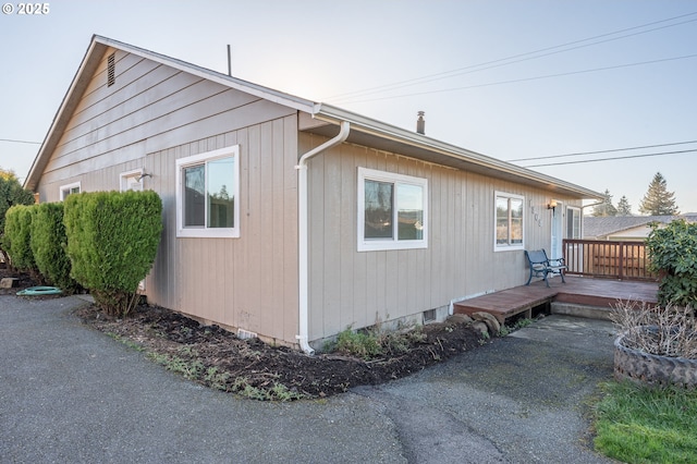 view of property exterior with a deck