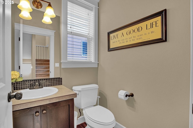14670 SW 78th Ave, Tigard, OR 97224 - bathroom featuring toilet, vanity, and backsplash