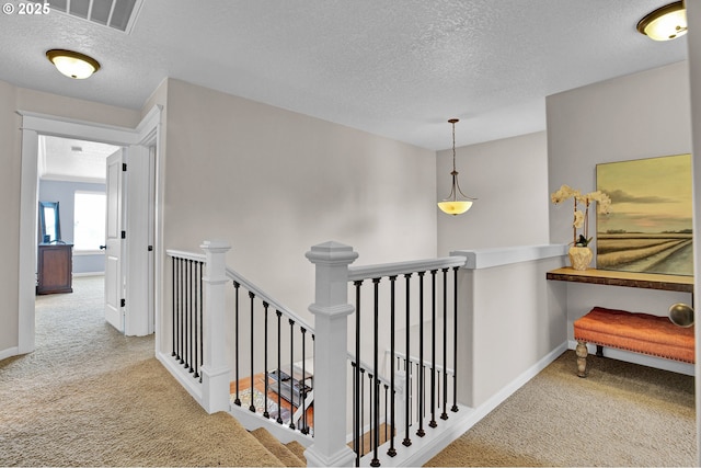 14670 SW 78th Ave, Tigard, OR 97224 - hallway featuring carpet flooring, an upstairs landing, a textured ceiling, and baseboards
