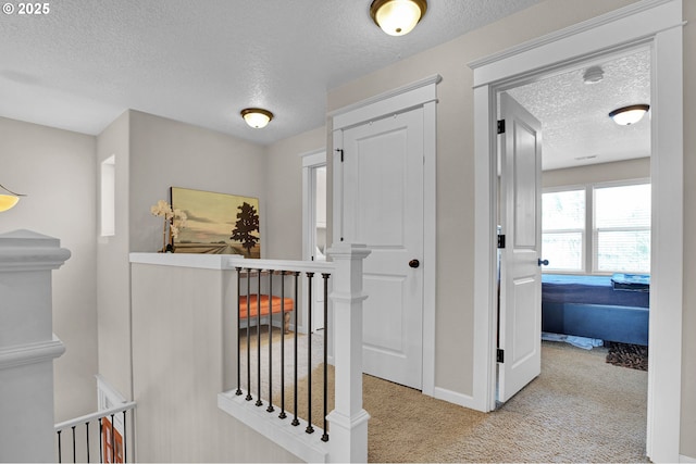 14670 SW 78th Ave, Tigard, OR 97224 - hall with an upstairs landing, a textured ceiling, carpet floors, and baseboards