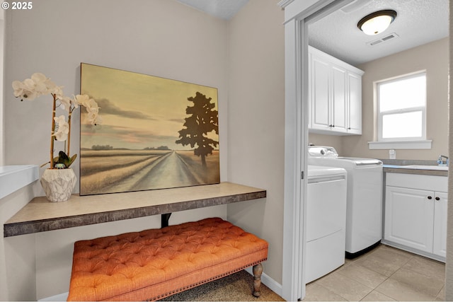 14670 SW 78th Ave, Tigard, OR 97224 - laundry room with washing machine and dryer, cabinet space, baseboards, and light tile patterned floors