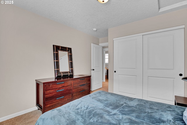 14670 SW 78th Ave, Tigard, OR 97224 - bedroom featuring light carpet, baseboards, a closet, and a textured ceiling