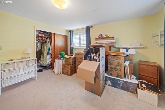 bedroom with light carpet and a closet