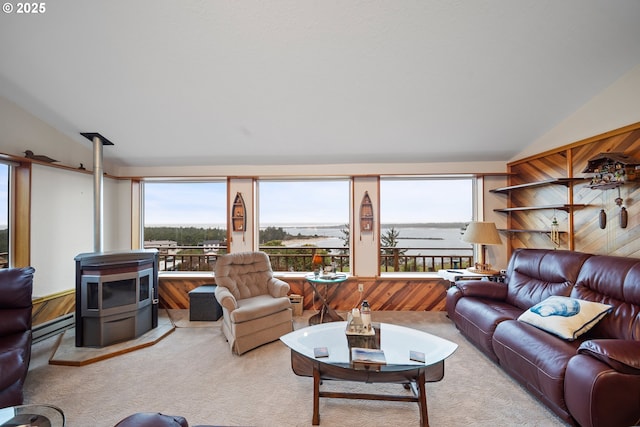 carpeted living room featuring lofted ceiling, a wood stove, and baseboard heating