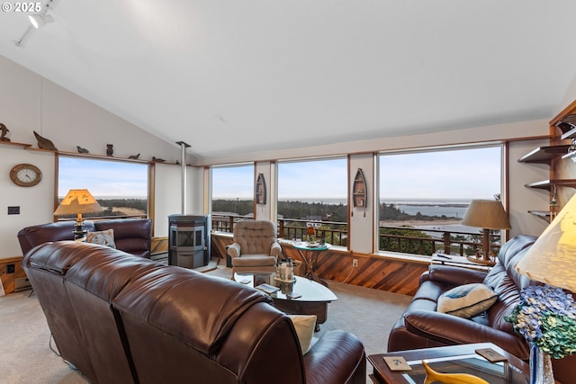 living room featuring light colored carpet, lofted ceiling, and a wealth of natural light