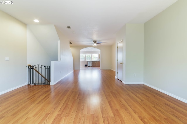 unfurnished room with baseboards, light wood finished floors, a ceiling fan, and recessed lighting