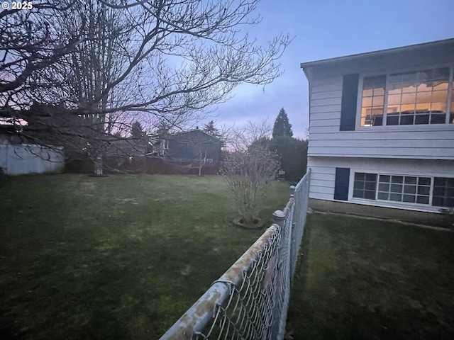 view of yard at dusk