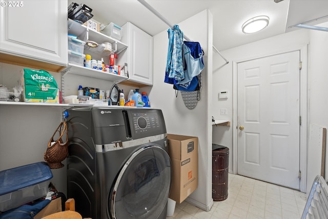 clothes washing area featuring cabinets