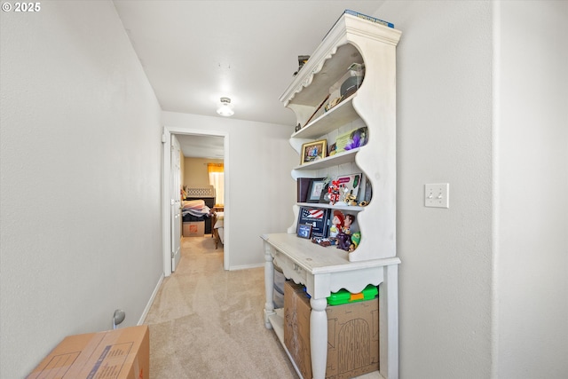 hall featuring light colored carpet