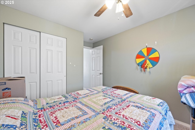 carpeted bedroom with ceiling fan and a closet